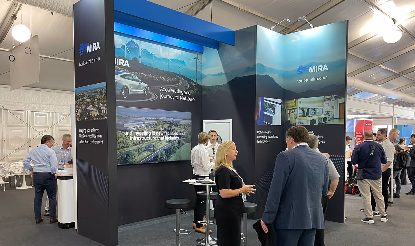 Conference booth display featuring prominent net zero messaging showing HORIBA MIRA’s leadership
